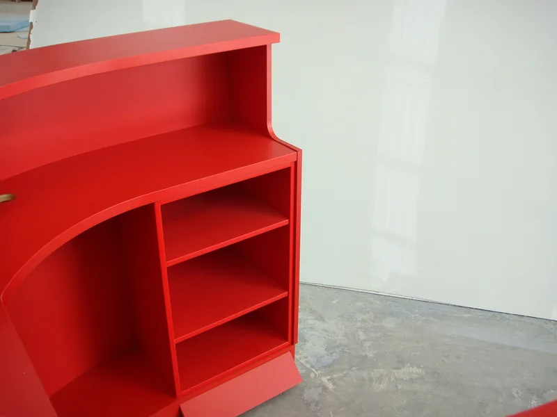 Red fibreglass workstation with shelving – terminal service counter design